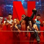 A group of wrestlers in a ring, with a giant red letter 'N' behind them