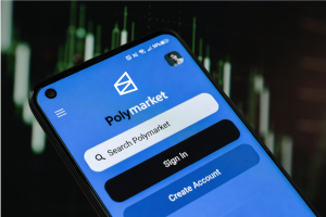 Polymarket aperta as regras de negociação com informações privilegiadas à Interface do aplicativo Polymarket no smartphone mostrando plataforma de negociação de mercado de previsão com histórico de gráfico financeiro e tela de login do usuário. Polymarket aperta as regras de negociação com informações privilegiadas à medida que o escrutínio cresce nos mercados de previsão