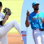 O arremessador inicial Kyle Freeland nº 21 das Montanhas Rochosas do Colorado em um uniforme branco com listras pretas arremessa durante o primeiro turno.