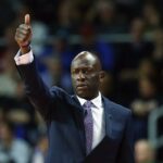 Treinador de basquete Cornell gesticulando na quadra.