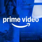 Uma caixa de entrega do Amazon Prime e o site da Amazon em segundo plano.