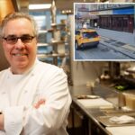 Um táxi amarelo numa rua da cidade em frente a um prédio com um