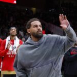 Washington Wizards guard Trae Young waves to crowd at Atlanta Hawks game