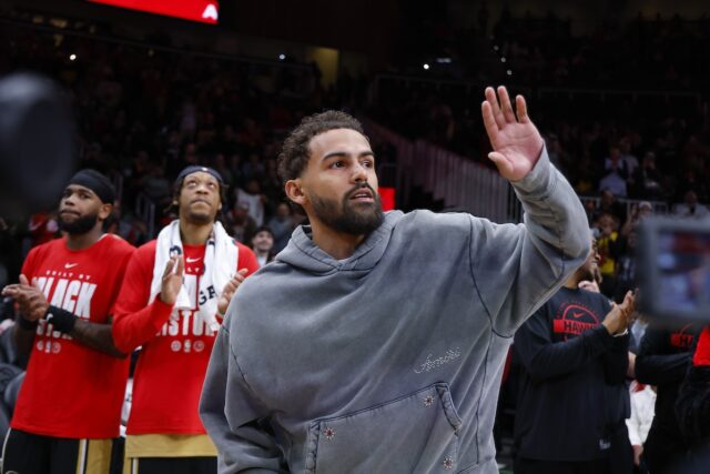 Washington Wizards guard Trae Young waves to crowd at Atlanta Hawks game