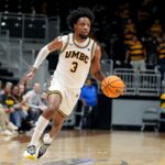 UMBC basketball player DJ Armstrong dribbles against Bryant