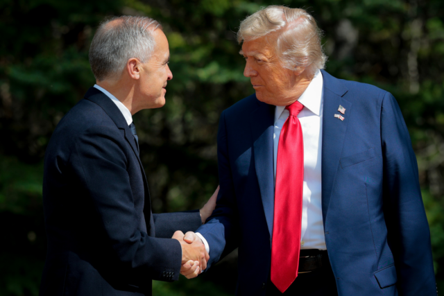 Canadian Prime Minister Mark Carney greets U.S. President Donald Trump at the official welcome ceremony during the G7 Leaders' Summit on June 16, 2025 in Kananaskis, Alberta.