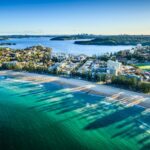 Aerial view of Sydney cityscape with ocean in foreground