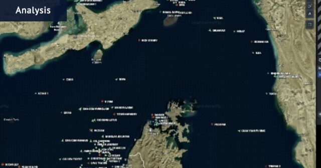 Um barco passa por um navio-tanque ancorado no Estreito de Ormuz, na costa da ilha de Qeshm, no Irã, no sábado.