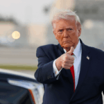 President Donald Trump waves to the media after walking off of Air Force One at Miami International Airport on April 11, 2026 in Miami, Florida.