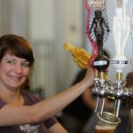 A placa da Angel City Brewery e a placa do Los Angeles Arts District na esquina de um prédio de tijolos.