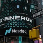 X-energy appears on a sign above the Nasdaq.