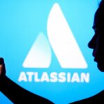 an Atlassian logo on a blue background with a person silhouetted in front holding a phone, for some reason