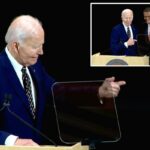 Joe Biden aponta para um pódio ao lado de um homem rindo.