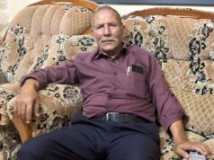 Ceticismo na Cisjordânia, já que os palestinos duvidam que as eleições locais mudem muito oliveiras com edifícios ao fundo