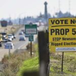 Uma placa amarela na beira de uma estrada que diz