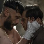 Dois adolescentes ficam frente a frente em um quarto.