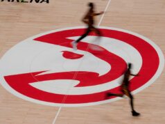Ex-executivo do Hawks que desviou mais de US$ 3,7 milhões da equipe foi condenado a mais de 3 anos de prisão Jogadores de basquete passam correndo pelo logotipo do Atlanta Hawks na quadra.