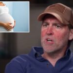 Mulher grávida segurando a barriga.