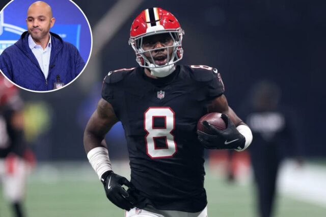 Um jogador do Atlanta Falcons com uma camisa preta com o número 8 e um capacete vermelho corre com a bola de futebol.