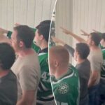 Vários homens, alguns vestindo camisetas verdes de hóquei do Dallas Stars, em pé e torcendo.