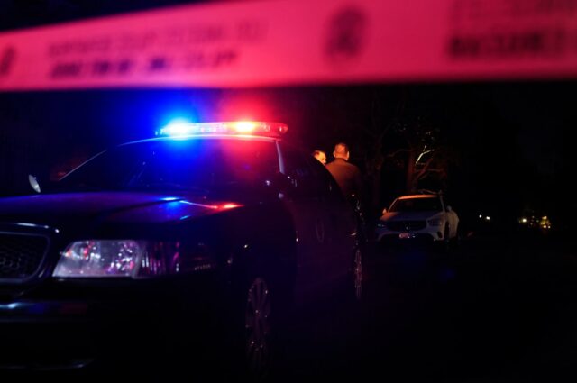 LAPD officers keep watch as the police investigate two people found dead in Rob Reiner's home on December 14, 2025 in Brentwood, California.
