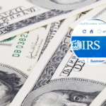 A wad of dollars, close up - stock photo and (inset) IRS website through a magnifying glass Izmir, Turkey - June 12, 2012 - stock photo