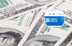 IRS anuncia ajuda de última hora para declaração de impostos para milhões A wad of dollars, close up - stock photo and (inset) IRS website through a magnifying glass Izmir, Turkey - June 12, 2012 - stock photo