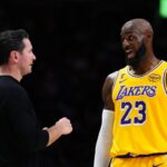 Lakers coach JJ Redick speaks to star player LeBron James at Heat game