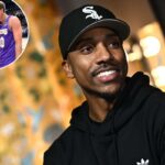 O astro aposentado da NBA, Jeff Teague, com capuz preto e boné de beisebol, parecendo certo com um sorriso.