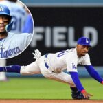 O shortstop do Los Angeles Dodgers, Mookie Betts, lança para a primeira base.