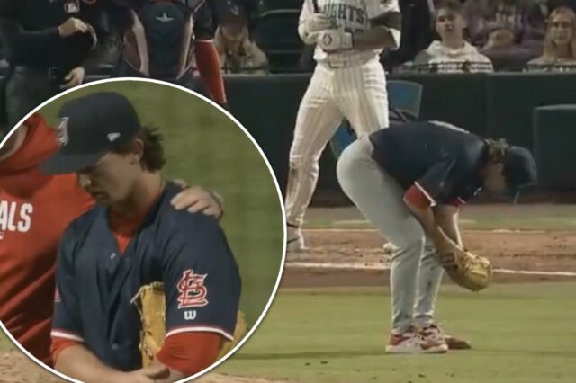 Um arremessador de beisebol se curva no monte após uma lesão, enquanto o receptor e o árbitro se aproximam dele.