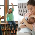 Uma jovem com um longo rabo de cavalo sorri enquanto amamenta seu bebê na cama.