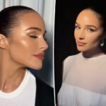 Frasco de soro em spray branco com bomba dourada, com o logotipo d'Alba e detalhes do produto, sobre fundo branco com gotas de óleo amarelas.