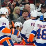 O assistente técnico do New York Islanders, Benoit Desrosiers, conversa com os defensores Scott Mayfield (24), Ryan Pulock (6), Isaiah George (36) e Matthew Schaefer (48) contra o Carolina Hurricanes.