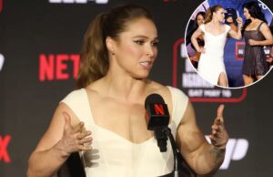 Ronda Rousey em paz com megaluta de Gina Carano no retorno do MMA sendo a última – com uma ressalva Ronda Rousey falando em entrevista coletiva com o logotipo da Netflix e detalhes do cartão de luta ao fundo.