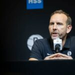 O GM do Brooklyn Nets, Sean Marks, fala ao microfone.