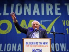 Um alerta sobre o ‘imposto bilionário’ — de 200 anos atrás O senador Bernie Sanders fala em um pódio em frente a uma faixa azul que diz