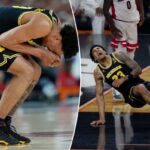 O atacante do Michigan, Yaxel Lendeborg, cai na quadra durante um jogo de basquete contra o Arizona.