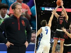 A escalação de basquete masculino da USC pode ficar completa com a adição de Isaac Bruns Um jogador de basquete com uniforme preto e vermelho atirando um arremesso sobre um jogador adversário.