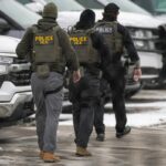 ICE agents depart the Bishop Henry Whipple Federal Building on February 4, 2026, in Minneapolis.