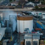 Water is sprayed on a tank that overheated at an aerospace plant in Garden Grove, California, on May 22. (AP Photo/Ethan Swope)