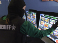 Autoridades da Flórida prendem rede de jogos ilegais do condado de Manatee durante operação de fiscalização Investigador do xerife da Flórida examina máquinas caça-níqueis ilegais durante operação de fiscalização de fliperamas no condado de Manatee e repressão aos jogos em todo o estado da Flórida