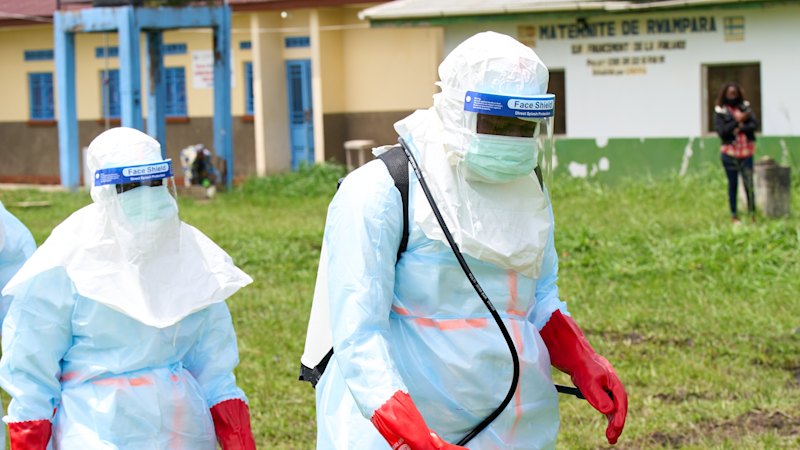 Profissionais de saúde preparam desinfecção num centro de tratamento na República Democrática do Congo.