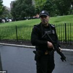 Um agente armado do Serviço Secreto reage na Casa Branca em Washington, DC, depois que tiros foram aparentemente ouvidos na noite de sábado