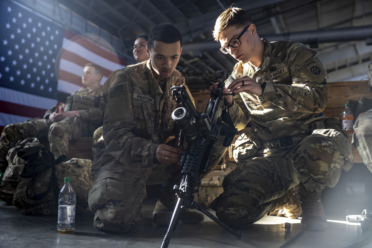 Members of the 82nd Airborne Division of the U.S. Army clean weaponry ahead of deployment to Poland from Fort Bragg, North Carolina on February 14, 2022.