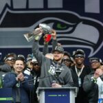 Sam Darnold #14 of the Seattle Seahawks raises the Lombardi Trophy