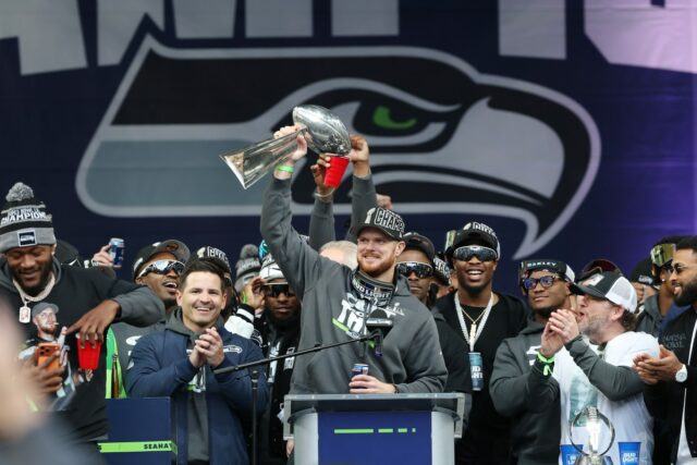 Sam Darnold #14 of the Seattle Seahawks raises the Lombardi Trophy