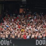 Shirtless fans cheer