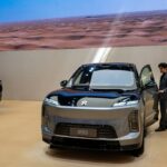 A sales person opens the door of an ES9 electric SUV made by Chinese automaker NIO at the Beijing International Auto Exhibition on April 25, 2026.