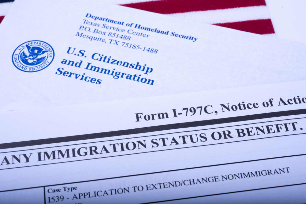 An official USCIS envelope is seen next to Form I - 797C (Notice of action, immigration status) and an American flag on September 20, 2018, in Washington, DC.